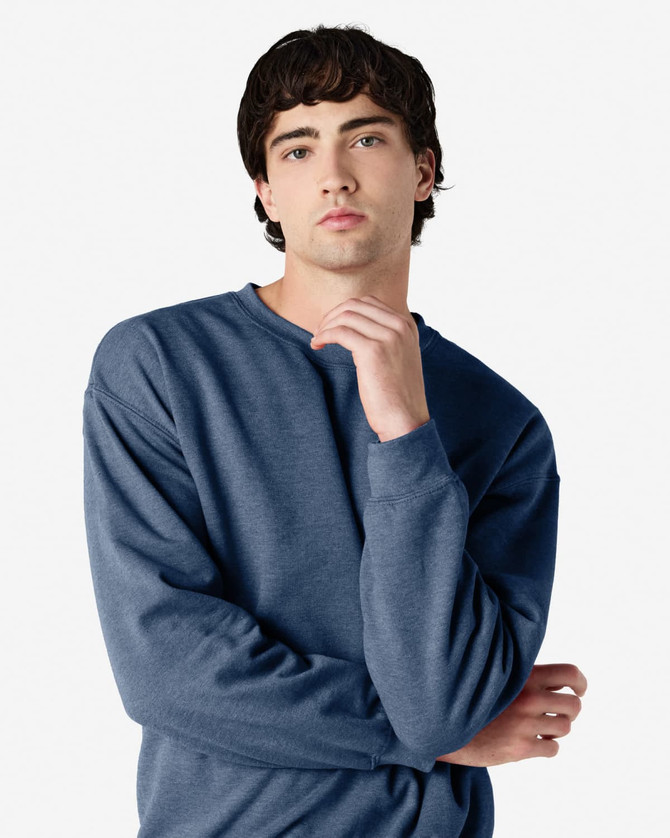 A blue Gildan Heavy Blend Adult Crewneck Sweatshirt on a model, featuring a casual fit and long sleeves.