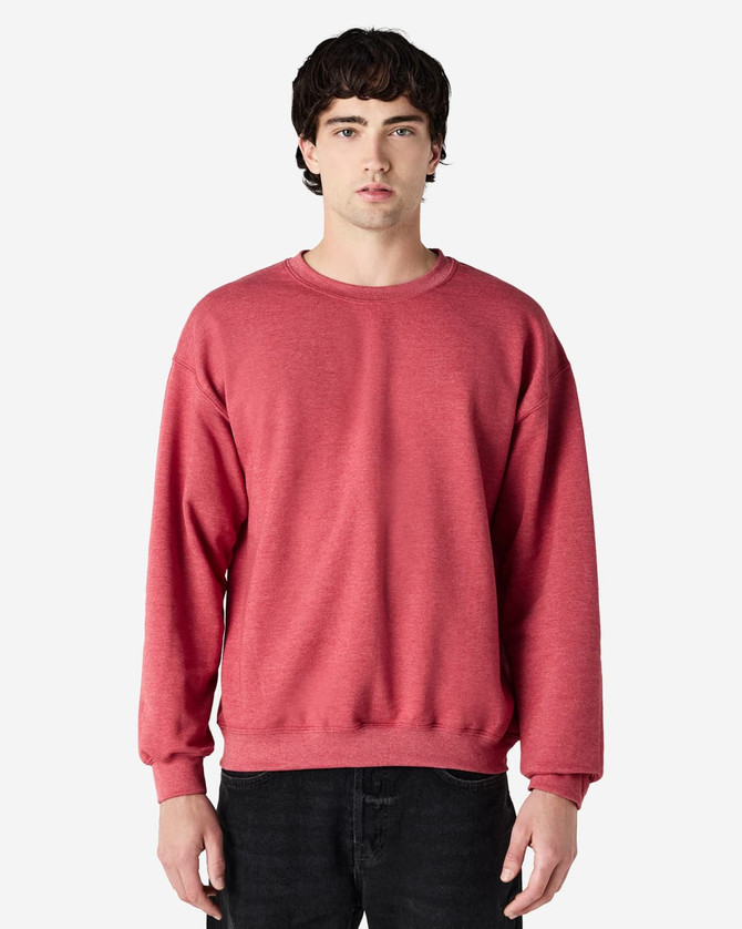 A red Gildan Heavy Blend adult crewneck sweatshirt displayed on a model, featuring a simple design and fitted silhouette.