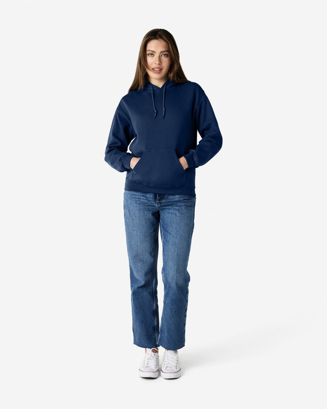 A navy blue Gildan Heavy Blend adult hooded sweatshirt worn by a model with jeans and sneakers. The sweatshirt features a hood and pockets.