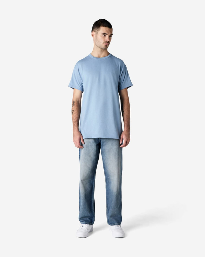 A light blue Gildan Ultra Cotton adult t-shirt on a model, paired with faded jeans and white shoes.