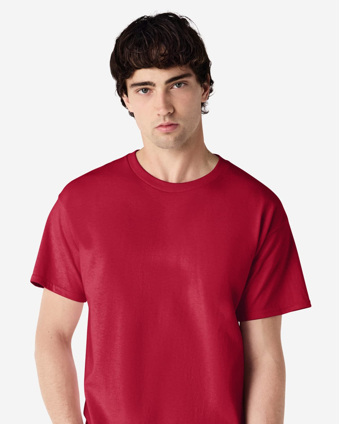 A red Gildan Ultra Cotton adult T-shirt displayed on a male model, featuring a simple design and a logo.
