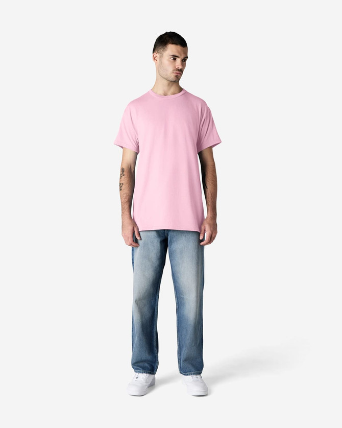 A pink Gildan Ultra Cotton adult T-shirt displayed on a model wearing black pants and sneakers, featuring a logo.