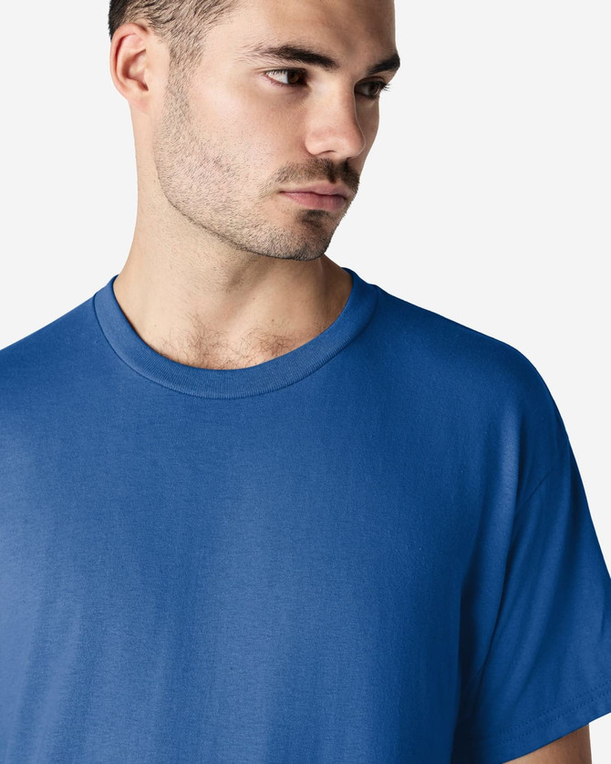 A blue Gildan Ultra Cotton adult T-shirt worn by a model, featuring a simple design and a logo.
