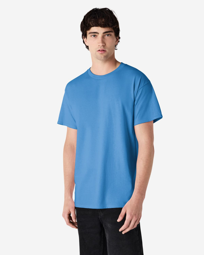 A blue Gildan Ultra Cotton adult T-shirt displayed on a model. The shirt features a logo and has a relaxed fit.