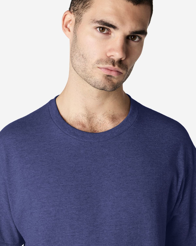 A model wearing a navy Gildan Ultra Cotton adult T-shirt with a crew neckline. The shirt has a logo on it.