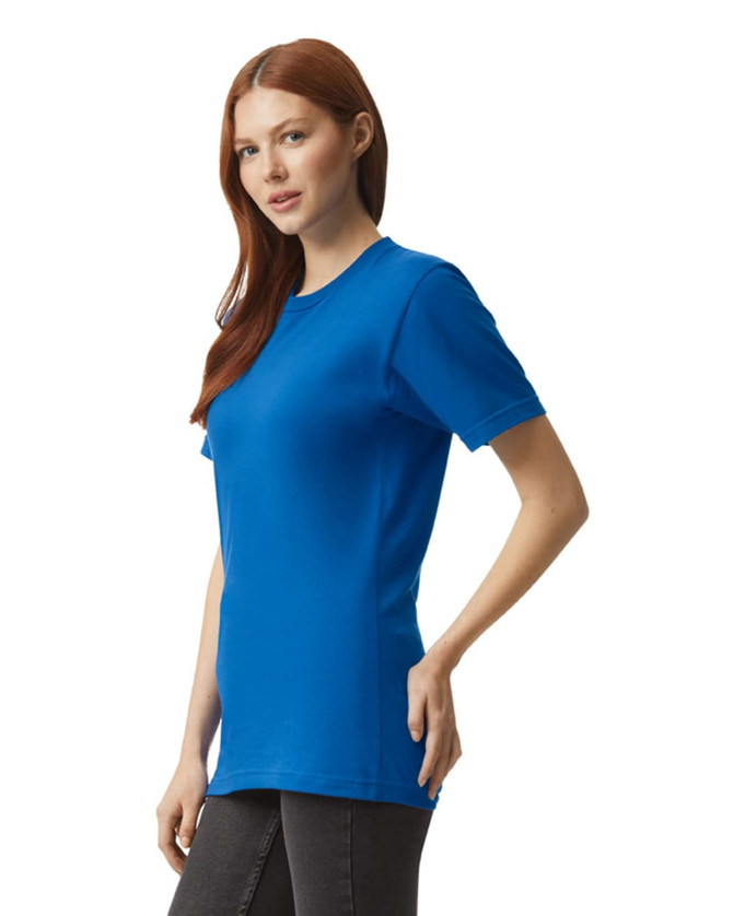 A unisex fine jersey short sleeve t-shirt in bright blue, featured on a model standing sideways.