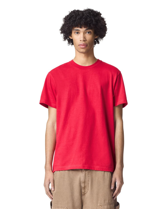 A red unisex fine jersey short sleeve t-shirt displayed on a model with curly hair. It features a logo.