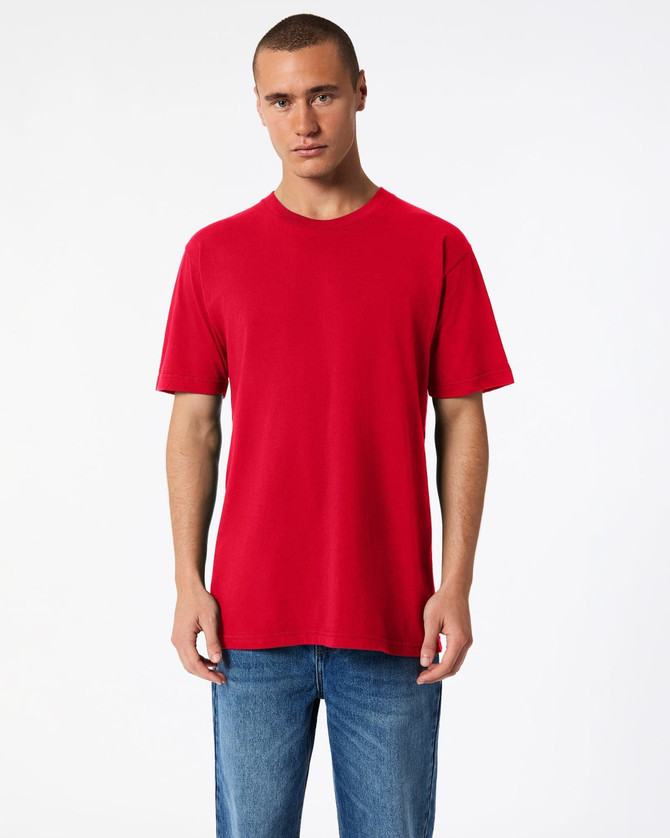 A red unisex fine jersey short sleeve T-shirt displayed on a model, featuring a plain design and a relaxed fit.