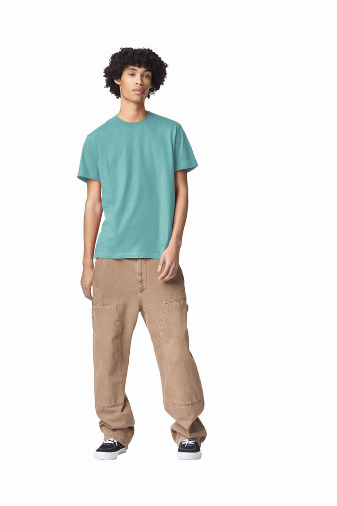 A unisex fine jersey short sleeve t-shirt in teal, paired with beige cargo pants, worn by a model.