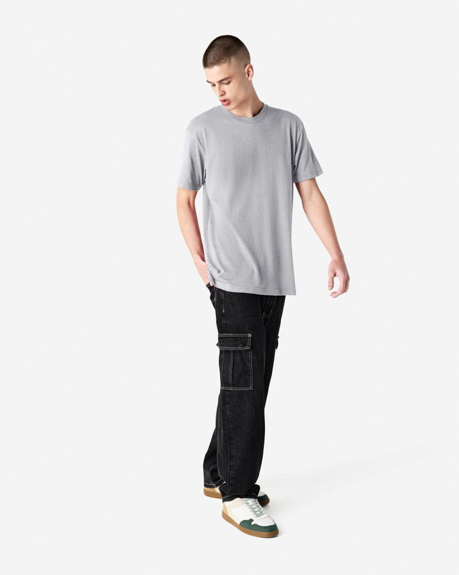 A grey unisex CVC short sleeve t-shirt worn with black cargo pants, featuring a simple design and casual fit.