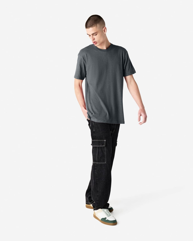 A unisex short sleeve T-shirt in grey paired with black cargo pants, featuring a simple design and a logo.
