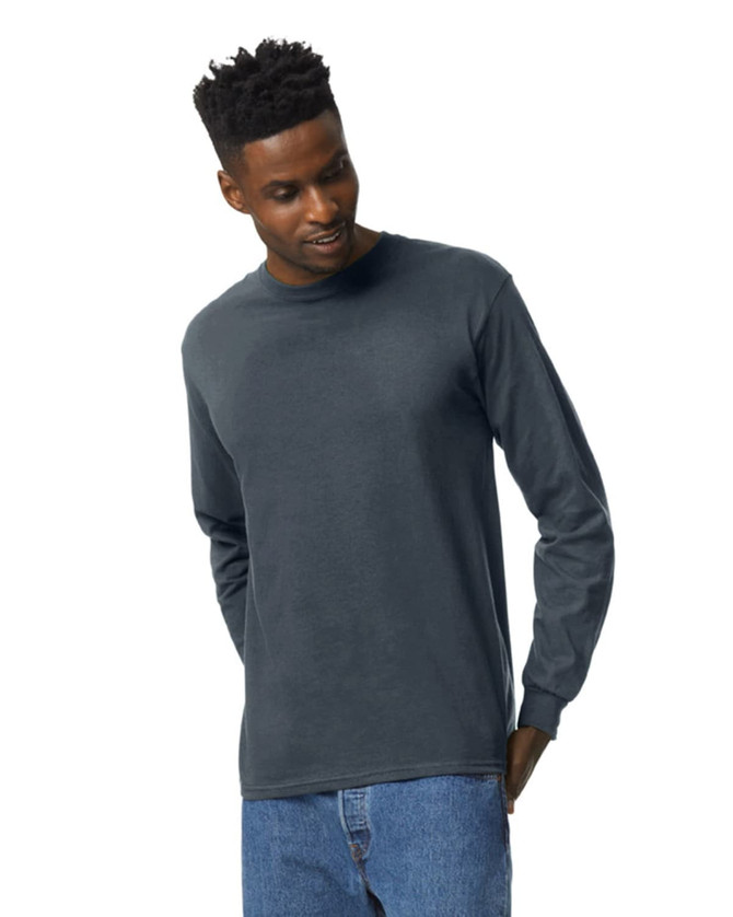 A long sleeve t-shirt in a dark grey colour, featuring a logo and worn by a man with short, styled hair.