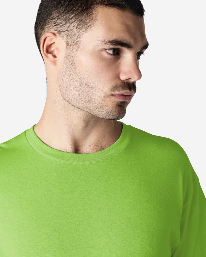 A man wearing a bright lime green Gildan Heavy Cotton adult t-shirt featuring a round neckline and visible branding.