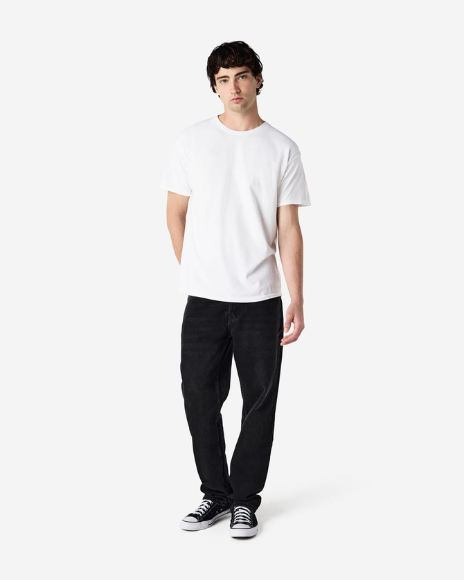 A white Gildan Heavy Cotton adult T-shirt displayed on a model wearing black jeans and sneakers.