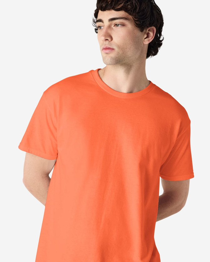 An orange Gildan Heavy Cotton Adult T-Shirt displayed on a model, featuring a simple design and logo.