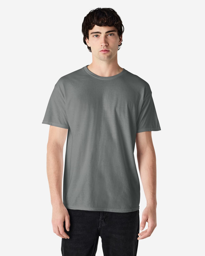 A grey Gildan Heavy Cotton Adult T-Shirt worn by a model, featuring a classic crew neck design and short sleeves.