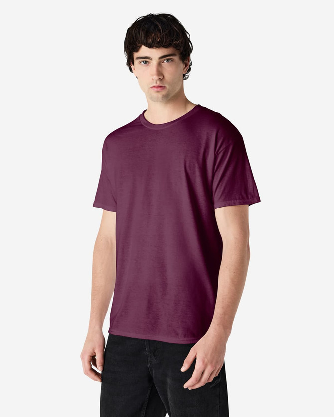 A man wearing a burgundy Gildan Heavy Cotton Adult T-Shirt, standing against a plain background.