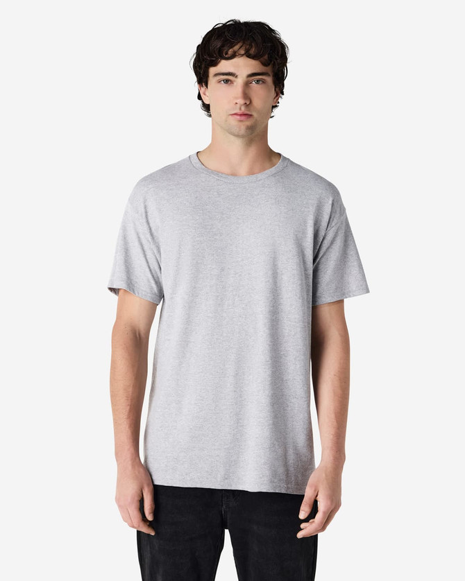A grey T-shirt with a relaxed fit, featuring a logo on the front, displayed on a male model.