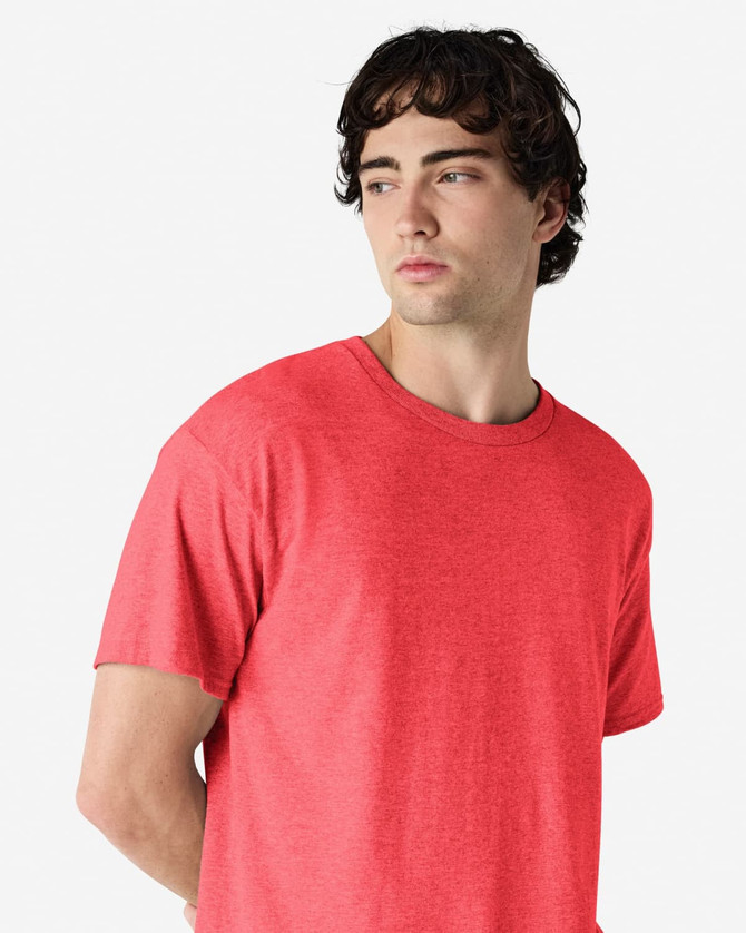 A red Gildan Heavy Cotton Adult T-Shirt on a model, featuring a simple design and a crew neck.
