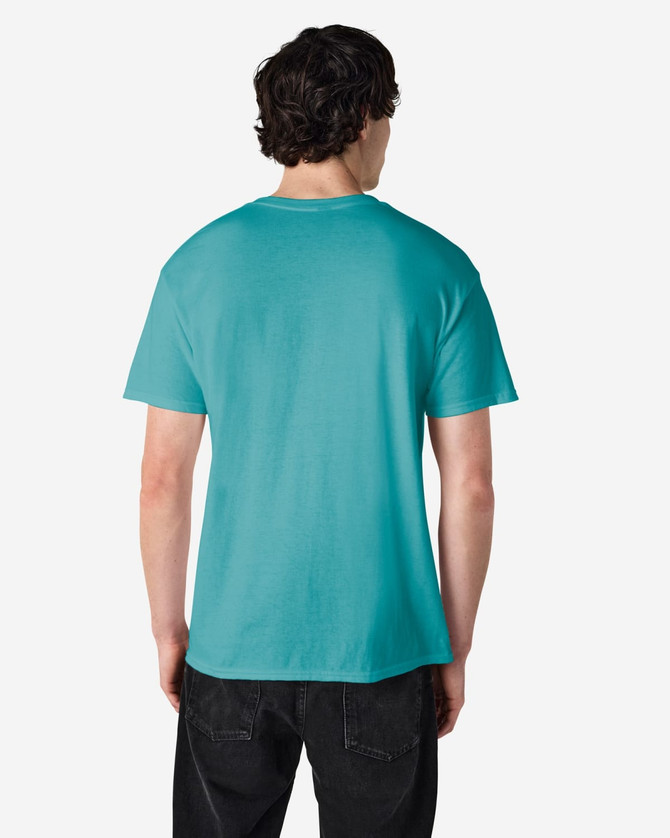 A man wearing a turquoise Gildan Heavy Cotton Adult T-Shirt, viewed from the back. The shirt has a logo.