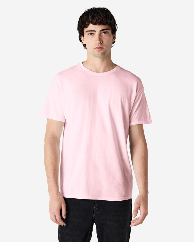 A pink Gildan Heavy Cotton Adult T-Shirt on a model, featuring a simple design and no visible logos.