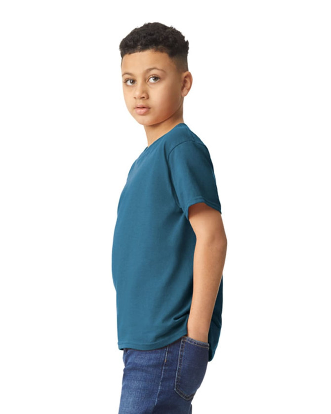 A youth t-shirt in teal, featuring short sleeves and a relaxed fit, displayed on a young model.