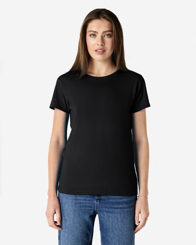 A black Gildan Heavy Cotton Ladies' T-Shirt displayed on a model, featuring short sleeves and a relaxed fit.
