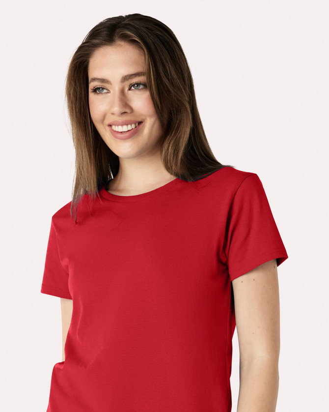 A red Gildan Heavy Cotton ladies' t-shirt is displayed, worn by a smiling woman. It features a logo on the shirt.
