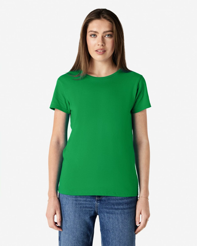 A green Gildan Heavy Cotton Ladies' T-Shirt displayed on a model wearing denim jeans. The shirt has a logo.