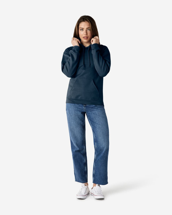 A model wearing a navy hooded sweatshirt and blue jeans, featuring a front pocket and a logo.