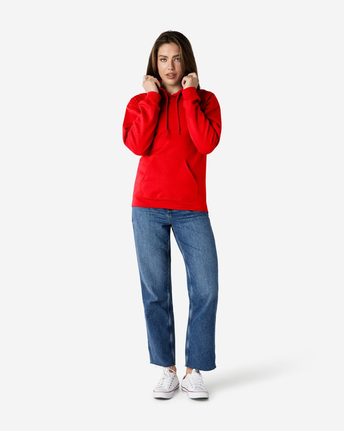 A red Gildan Softstyle adult hooded sweatshirt worn by a model, paired with blue jeans and white shoes.