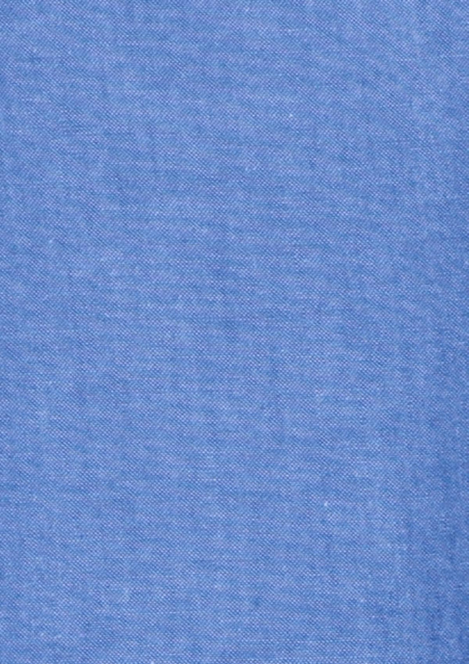 A blue chambray fabric, smooth and textured, ideal for a short sleeve button-up shirt. Features a subtle branding logo.