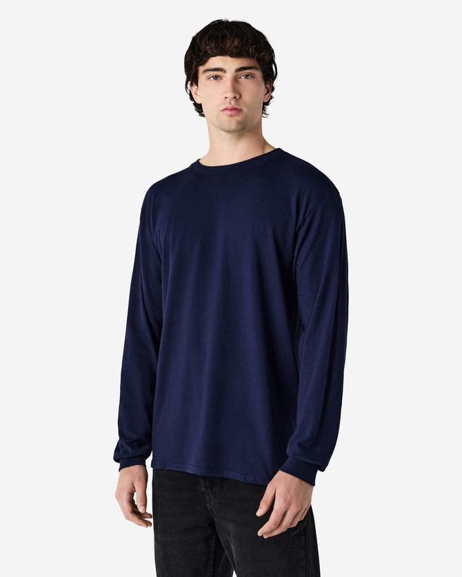A navy long sleeve T-shirt on a male model. The shirt features a simple design and has a logo.