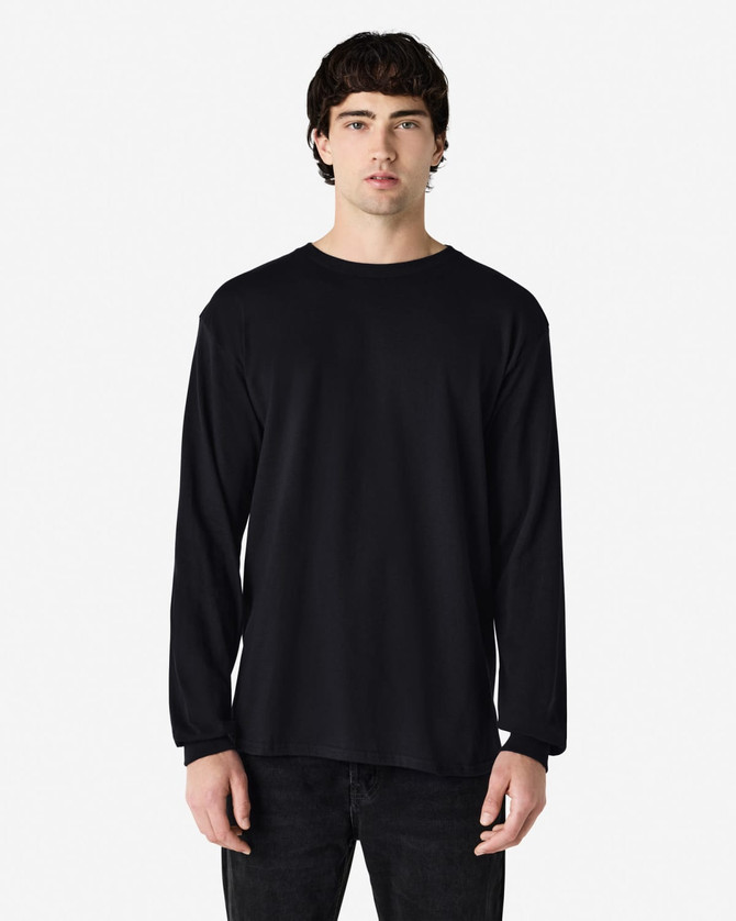 A black long sleeve t-shirt featured on a model, showcasing a simple design and a brand logo.