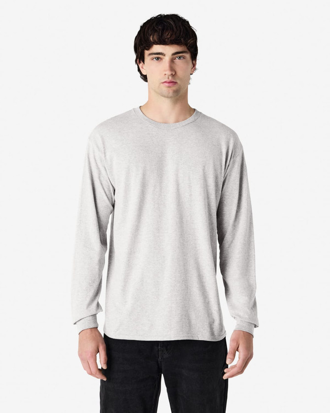 A light grey long sleeve t-shirt featuring a round neckline and a subtle branded logo.