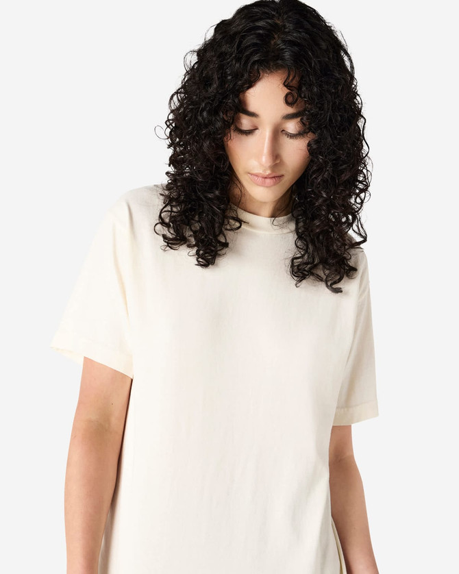 A unisex heavyweight cotton T-shirt in cream, featuring a relaxed fit and a subtle branding logo.
