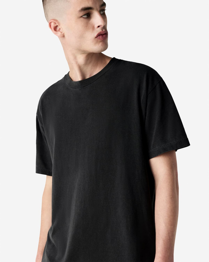 A unisex heavyweight cotton t-shirt in black, featuring a relaxed fit and a brand logo.
