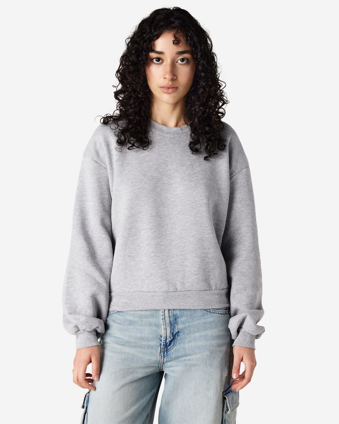 A grey women's crewneck sweatshirt with a relaxed fit and long sleeves, featuring a small logo.