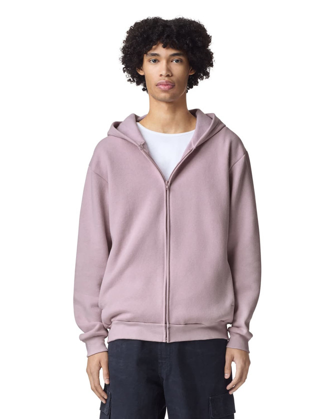 A unisex full zip hooded sweatshirt in a soft pink colour, featuring a hood and a relaxed fit.
