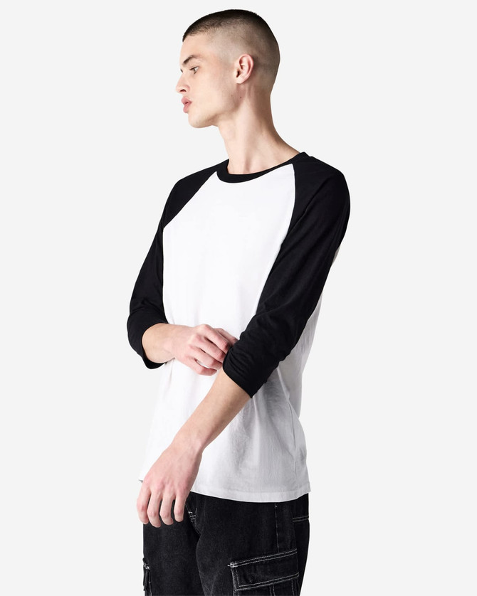 A black and white unisex raglan T-shirt with three-quarter sleeves. It features a logo on the sleeve.