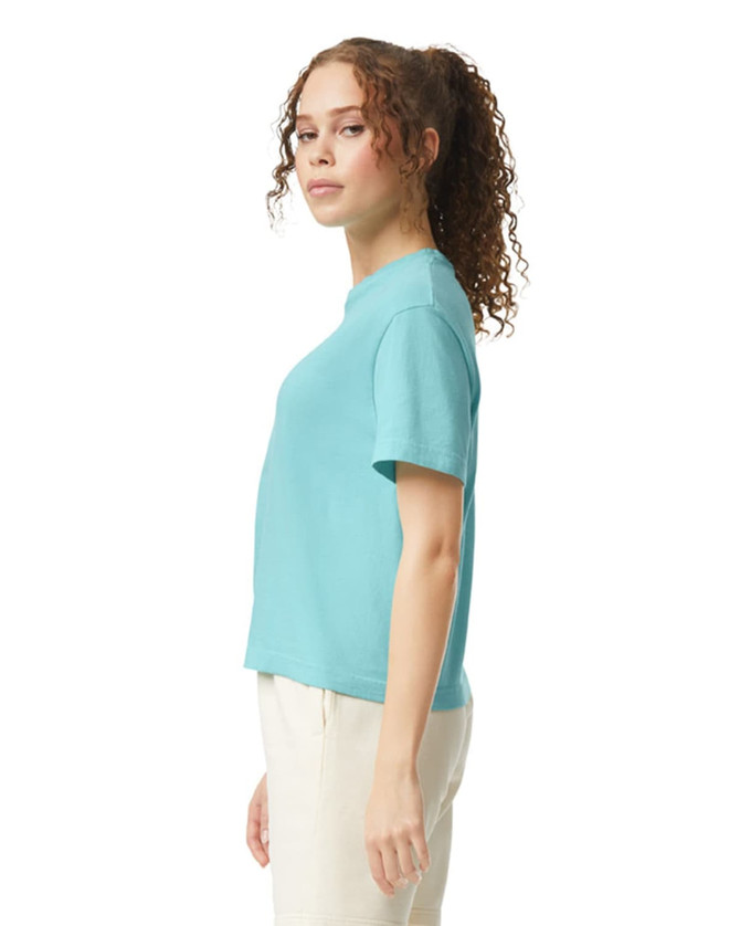 A turquoise women's heavyweight boxy T-shirt, featuring a simple design and a logo on the side.