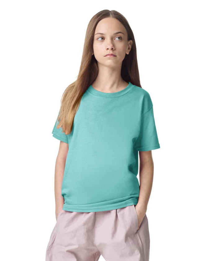 A teal youth t-shirt with short sleeves, featuring a logo on the front, displayed on a model.