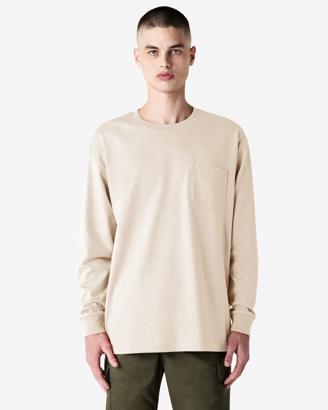 A lightweight, long-sleeve beige t-shirt featuring a pocket and a logo on the chest.