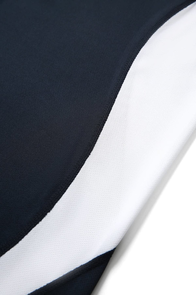A close-up of a men's polo shirt featuring a navy and white design, with visible stitching and texture.