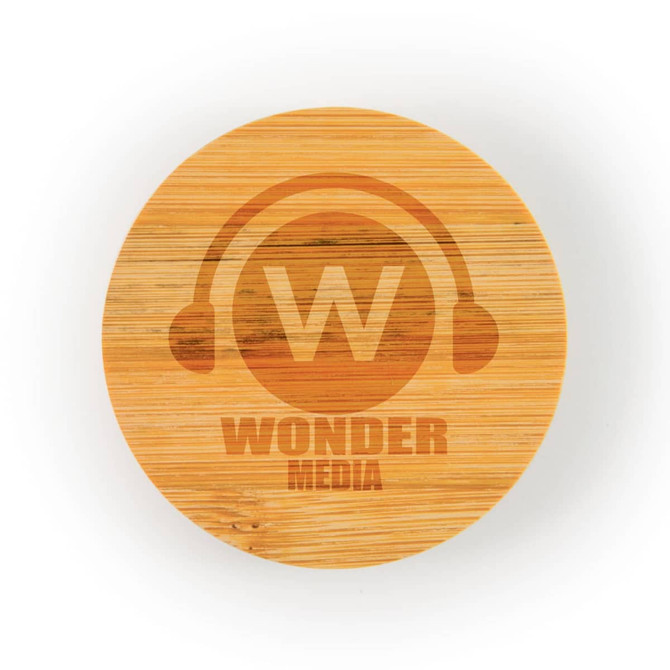 A round bamboo coaster features an engraved logo with the text "WONDER MEDIA" and a headphone graphic.