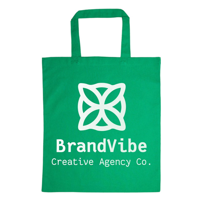A green cotton tote bag with a large white logo featuring a flower design and the text "BrandVibe Creative Agency Co."