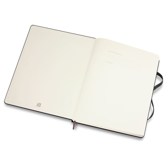 An extra-large, black Moleskine Classic hardcover notebook with blank pages and a ribbon marker.