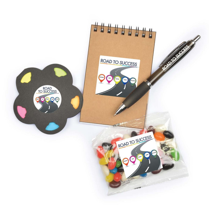 A notebook, a colorful sticky note pad, a pen, and a bag of assorted jelly beans, all featuring a logo.