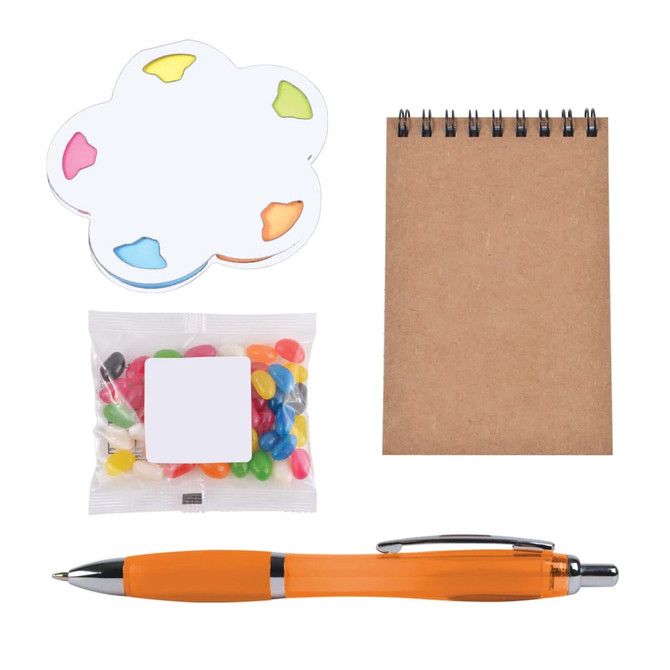An orange pen, a notepad, colorful sticky notes, and a bag of assorted jelly beans in a gift set.