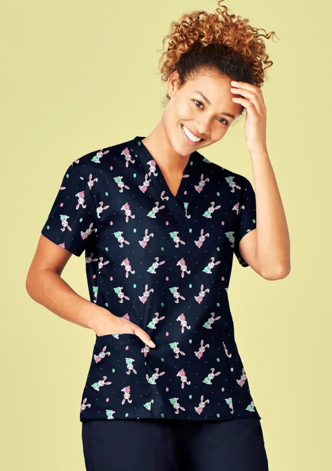 A navy V-neck scrub top featuring a playful Easter-themed pattern, with short sleeves and a pocket.